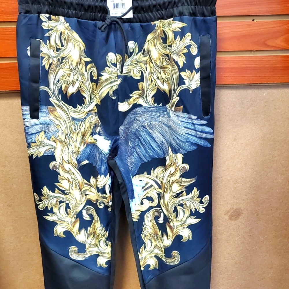Jogger style pants with detailed artwork of an eagle design.